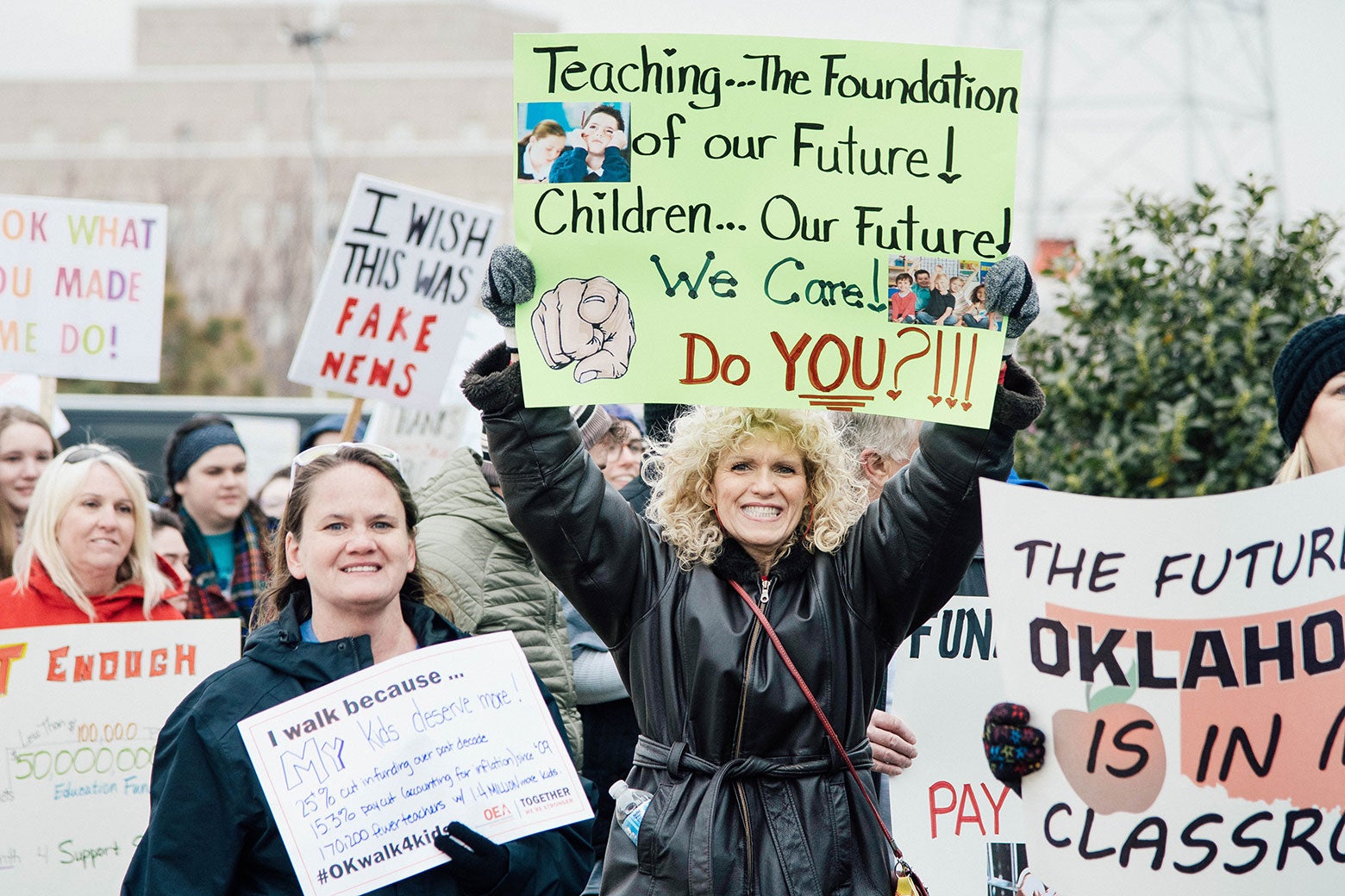 Protesting teachers hold up signs saying things like, "The future of Oklahoma is in the classroom."