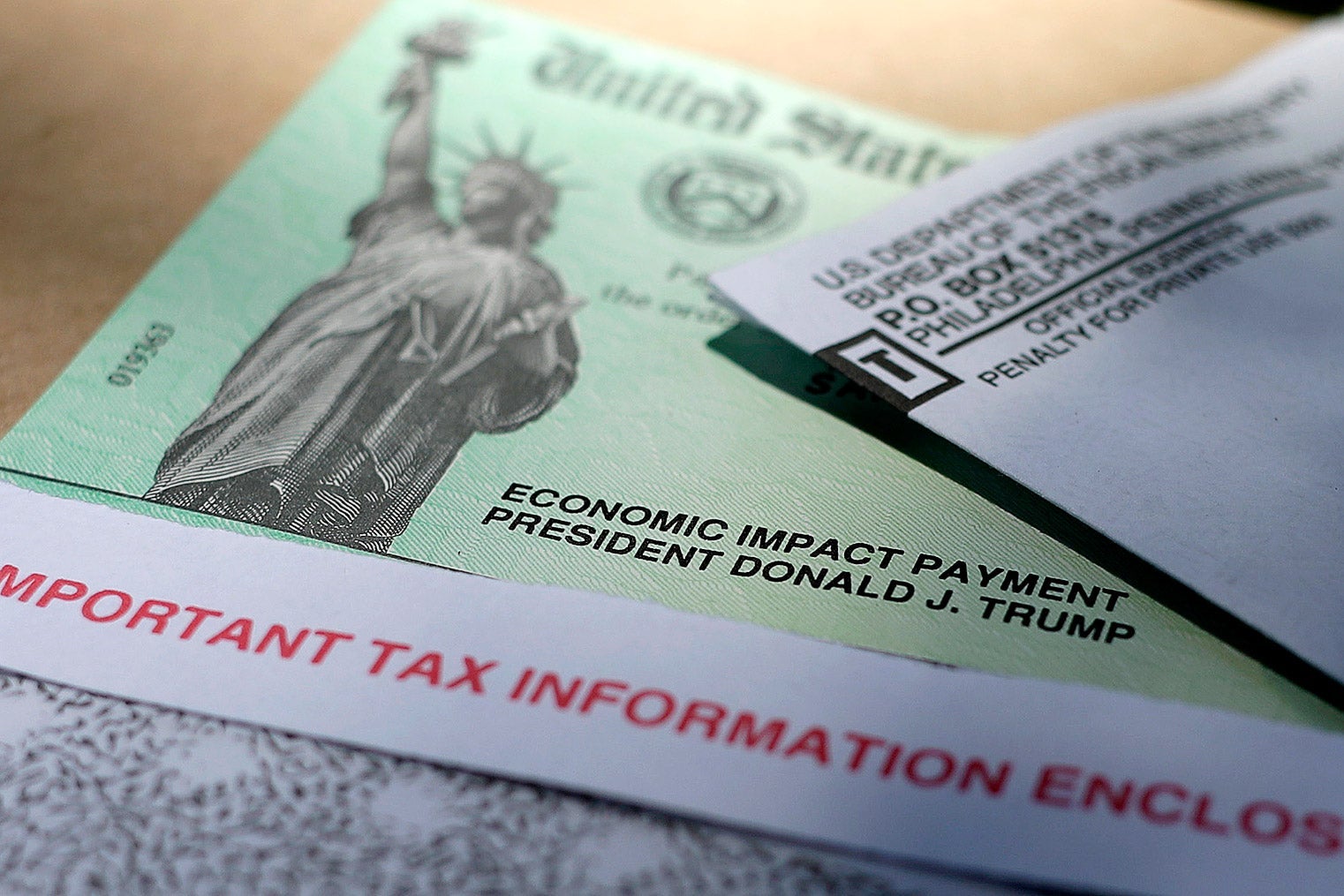 A United States treasury stimulus check on which an image of the Statue of Liberty and the words "Economic Impact Payment, President Donald J. Trump" can be seen.