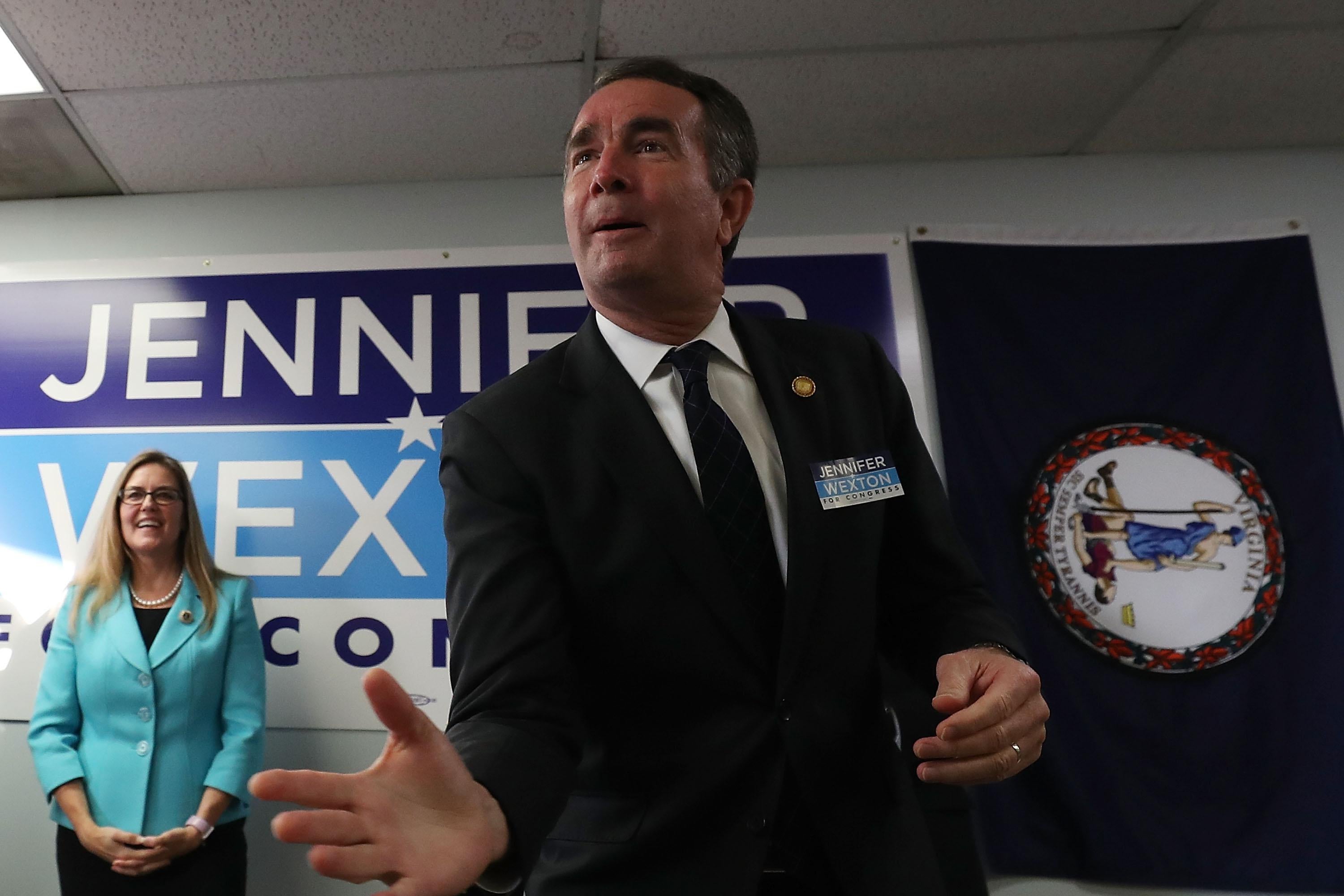 Virginia Gov. Ralph Northam speaks while flanked by Virginia State Senator and candidate for the U.S. House of Representatives Jennifer Wexton during a rally at the Wexton campaign headquarters on October 30, 2018 in Sterling, Virginia.