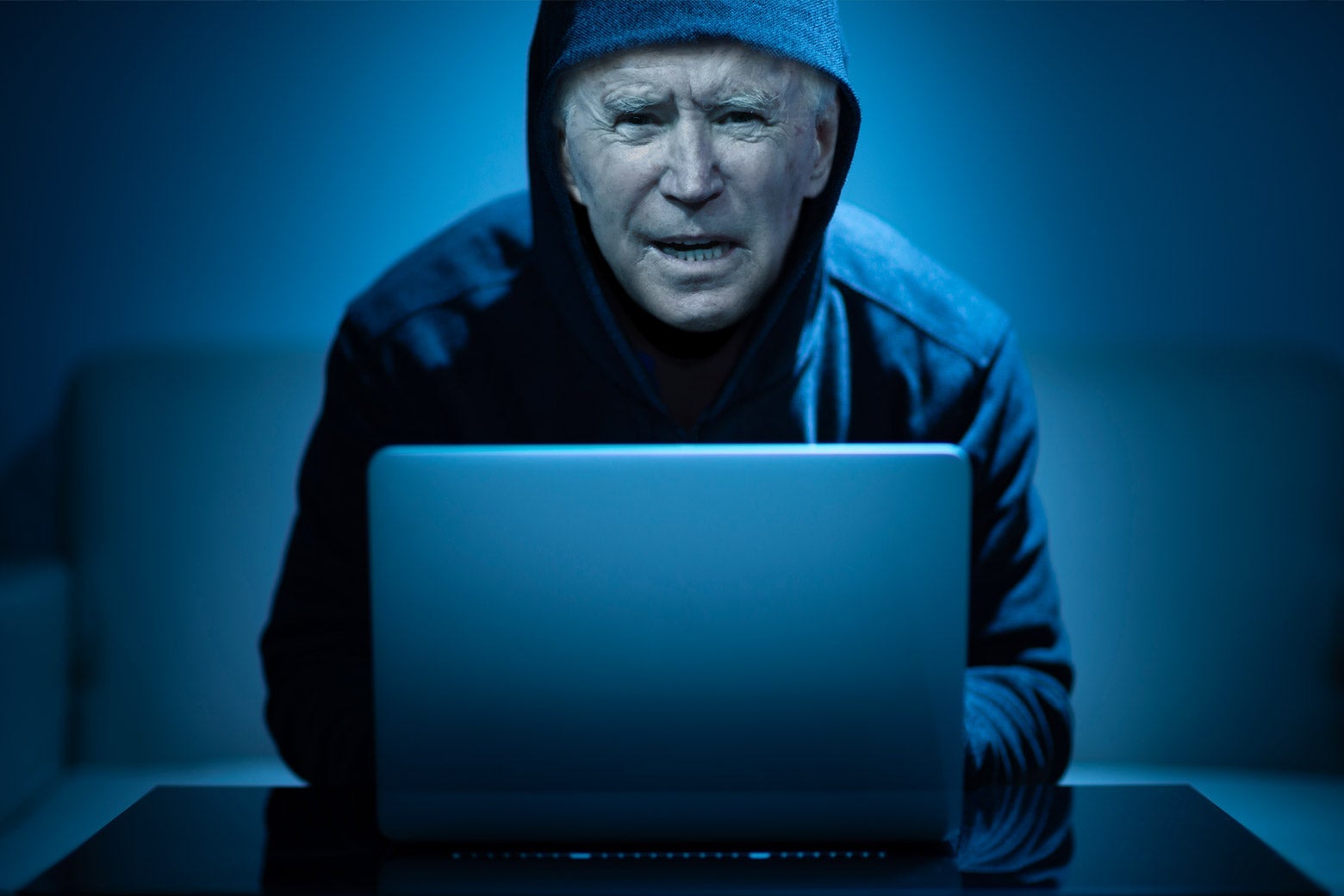 A manipulated photo of Joe Biden as a hacker in front of a laptop computer. 