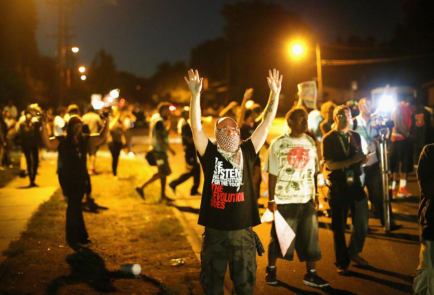 Demonstrators protest the shooting death of teenager Michael Brown on August 13, 2014 in Ferguson, Missouri. 