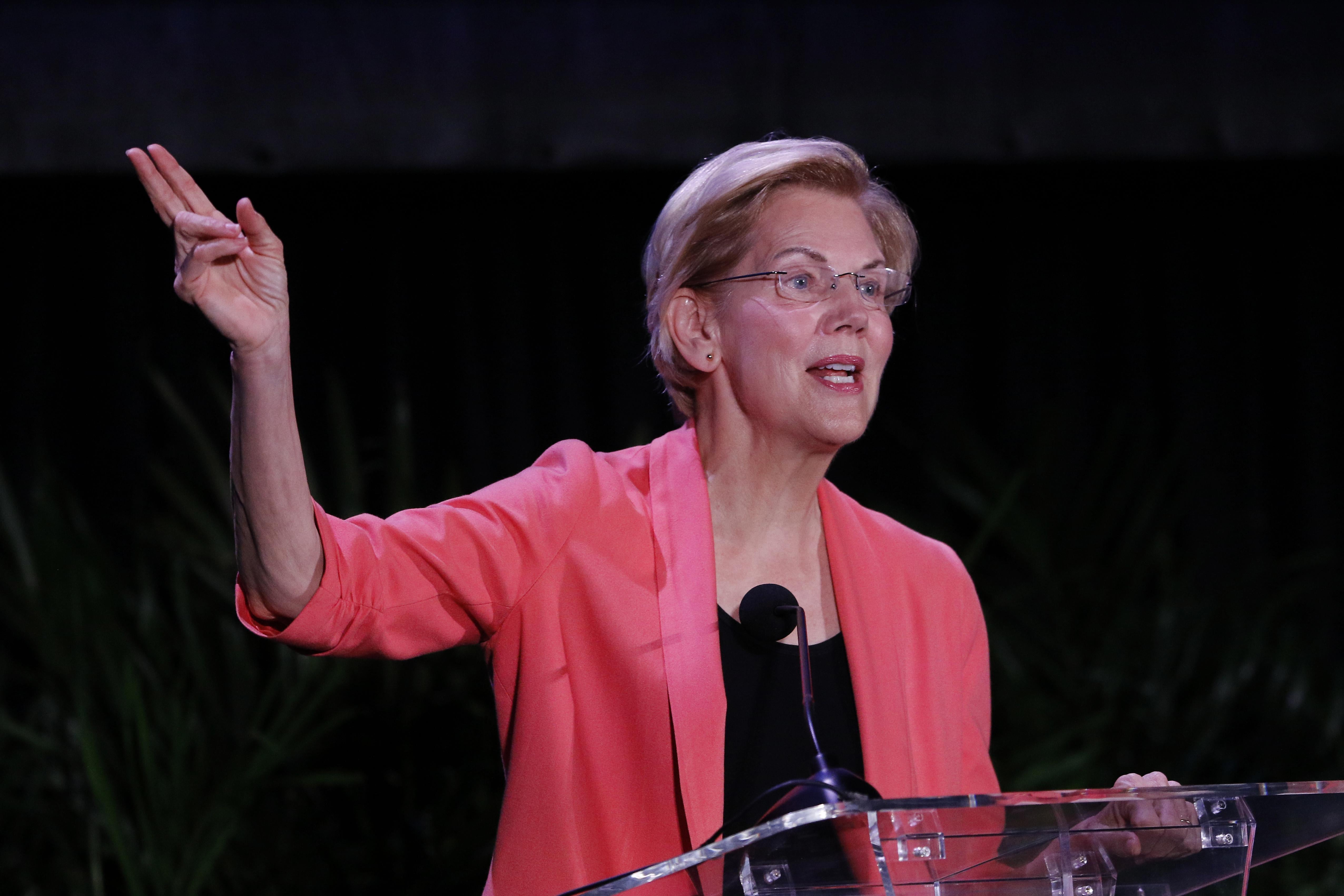 Warren speaks at a podium during the NALEO Presidential Candidate Forum in Miami on June 21.