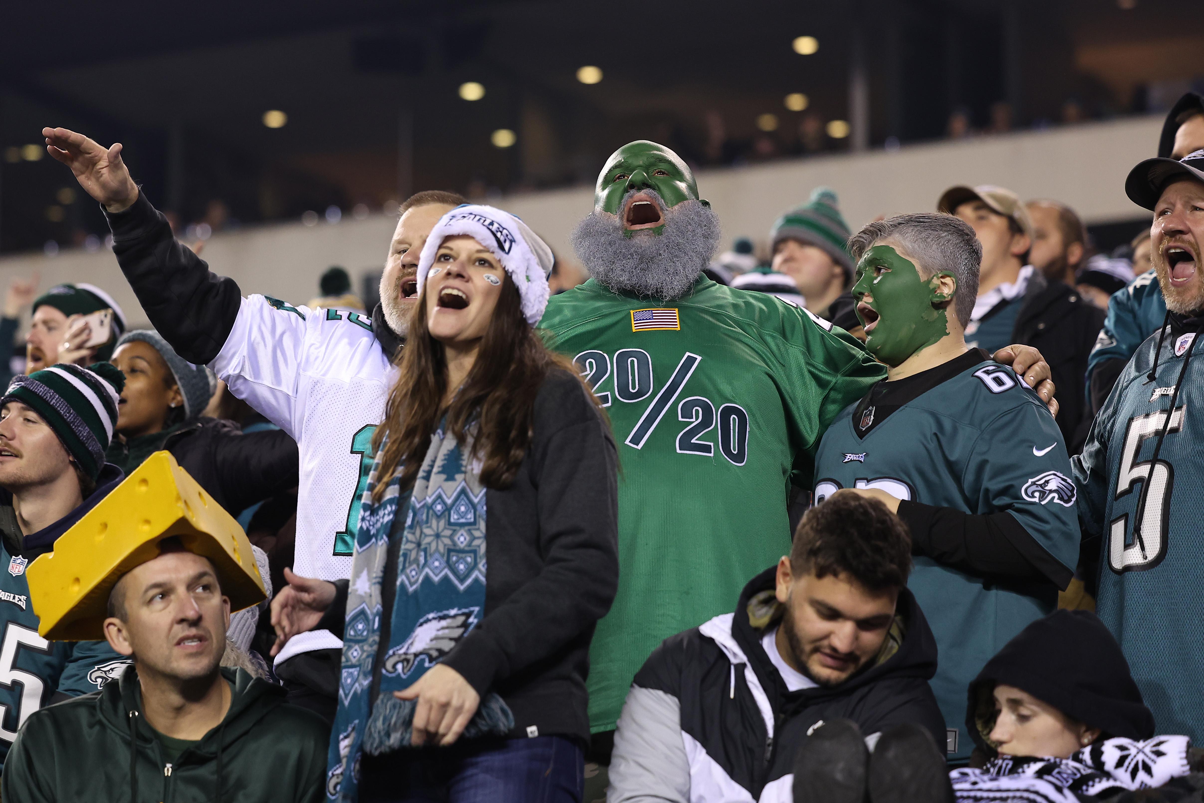 Two sports fans cheer for the Eagles.