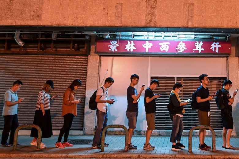 People wait in line to cast their votes during the district council elections in Tseung Kwan O district in Hong Kong on November 24, 2019.
