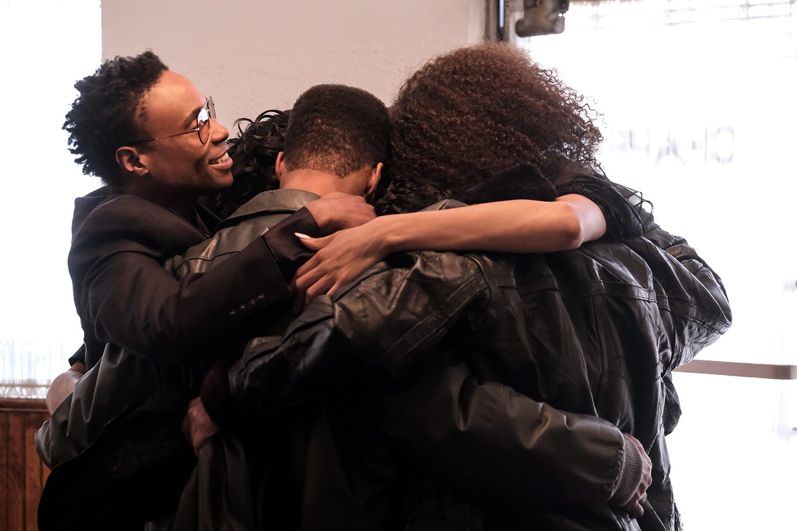 The characters engage in a group hug.