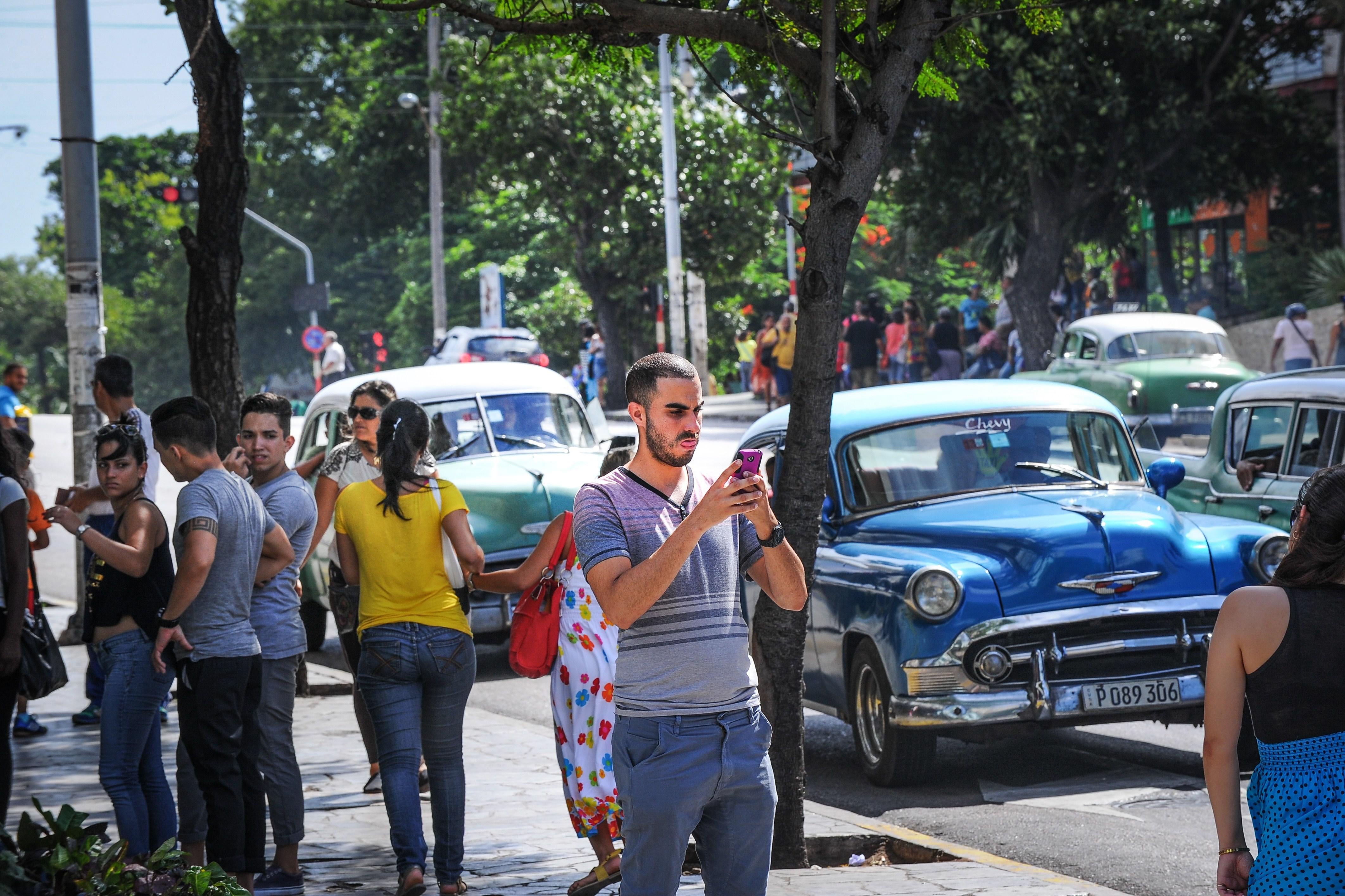 A man takes a picture with his mobile phone in Havana.