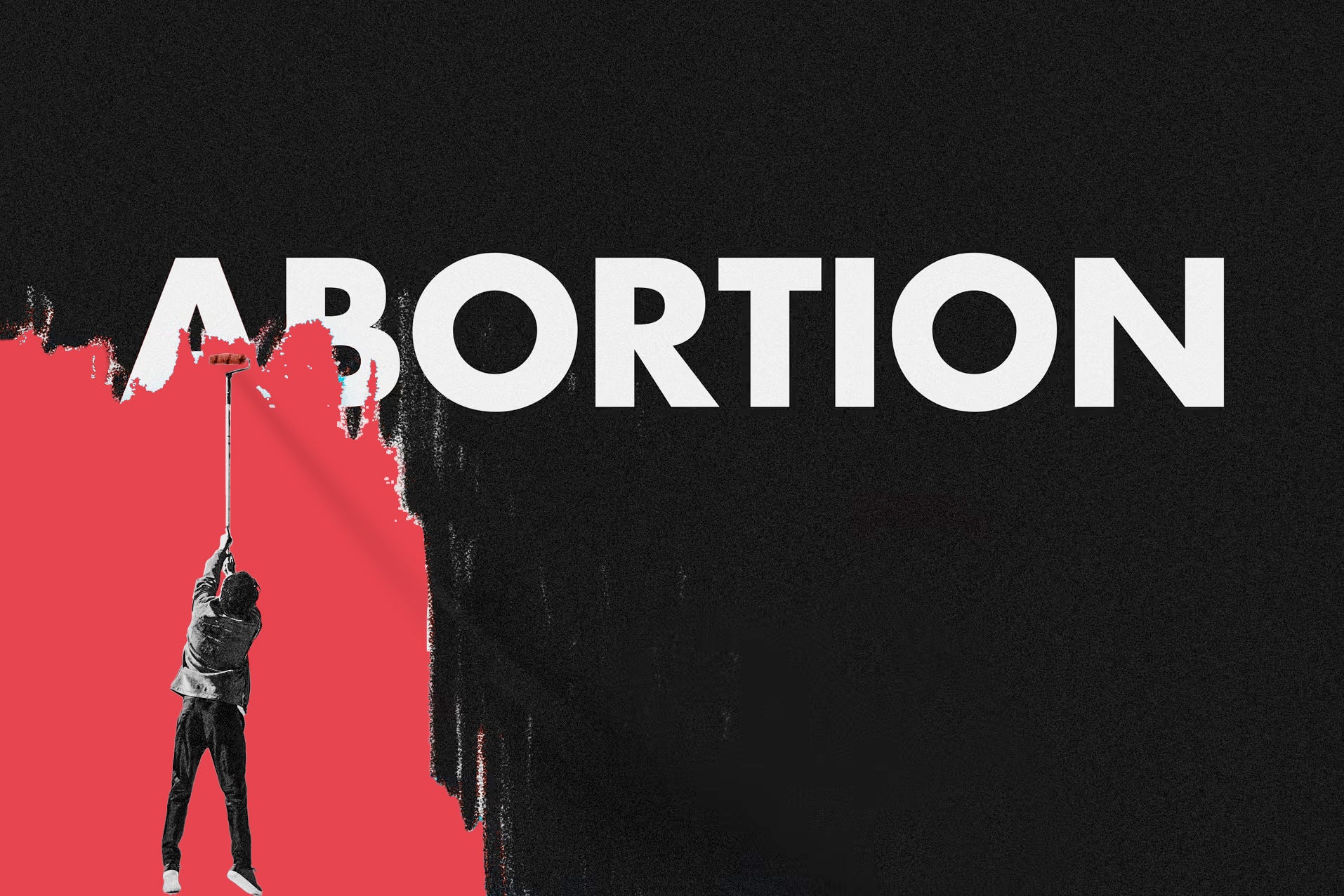 A person uses a paint roller to try to cover the word ABORTION with red paint.