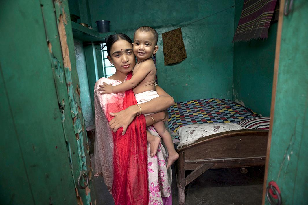 Labone, 27, takes a moment to hold her young daughter Nupur, 1, who was fathered by a client, before she has to return to her evening’s work in a brothel in Jessore, Bangladesh.