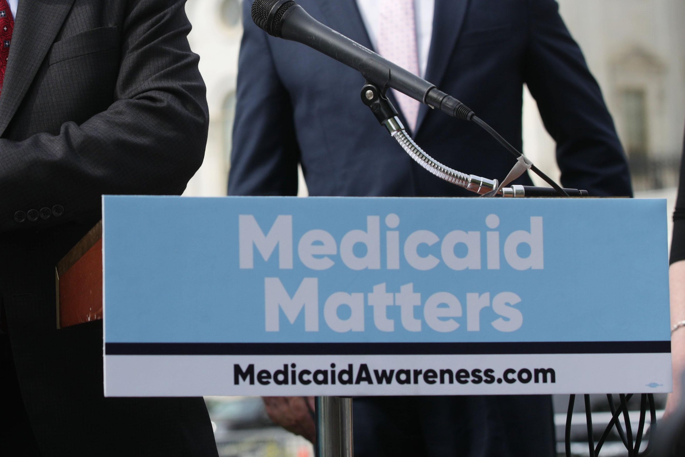 A sign on a podium says, "Medicaid Matters."