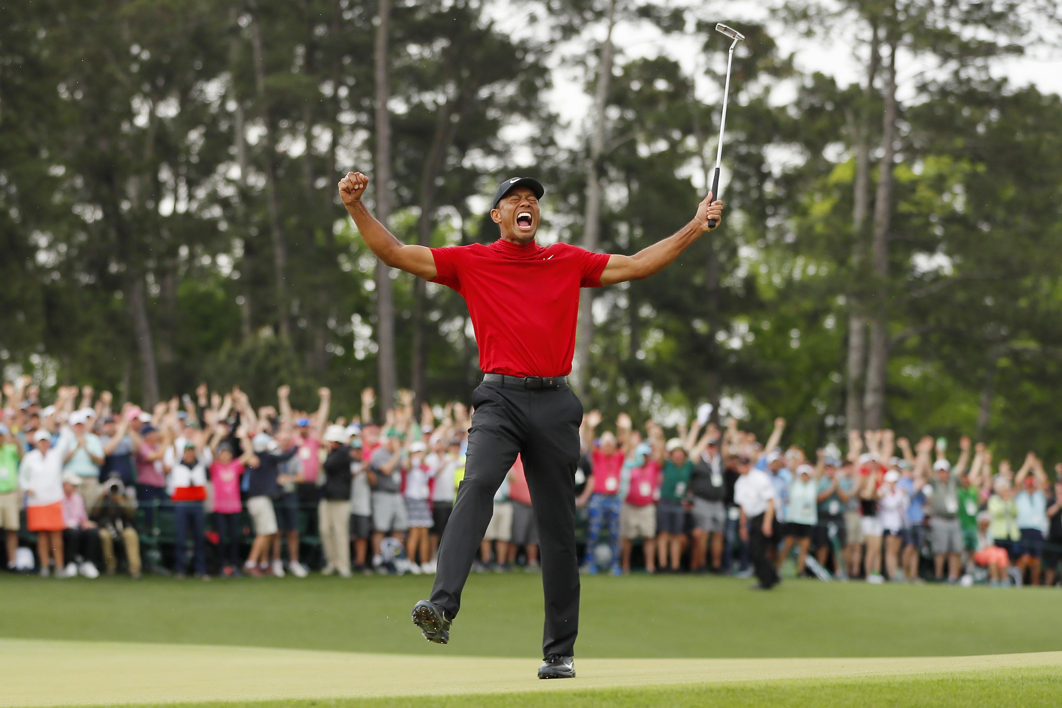 Tiger Woods  celebrates after sinking his putt on the 18th green to win the Masters, at Augusta National Golf Club on April 14.