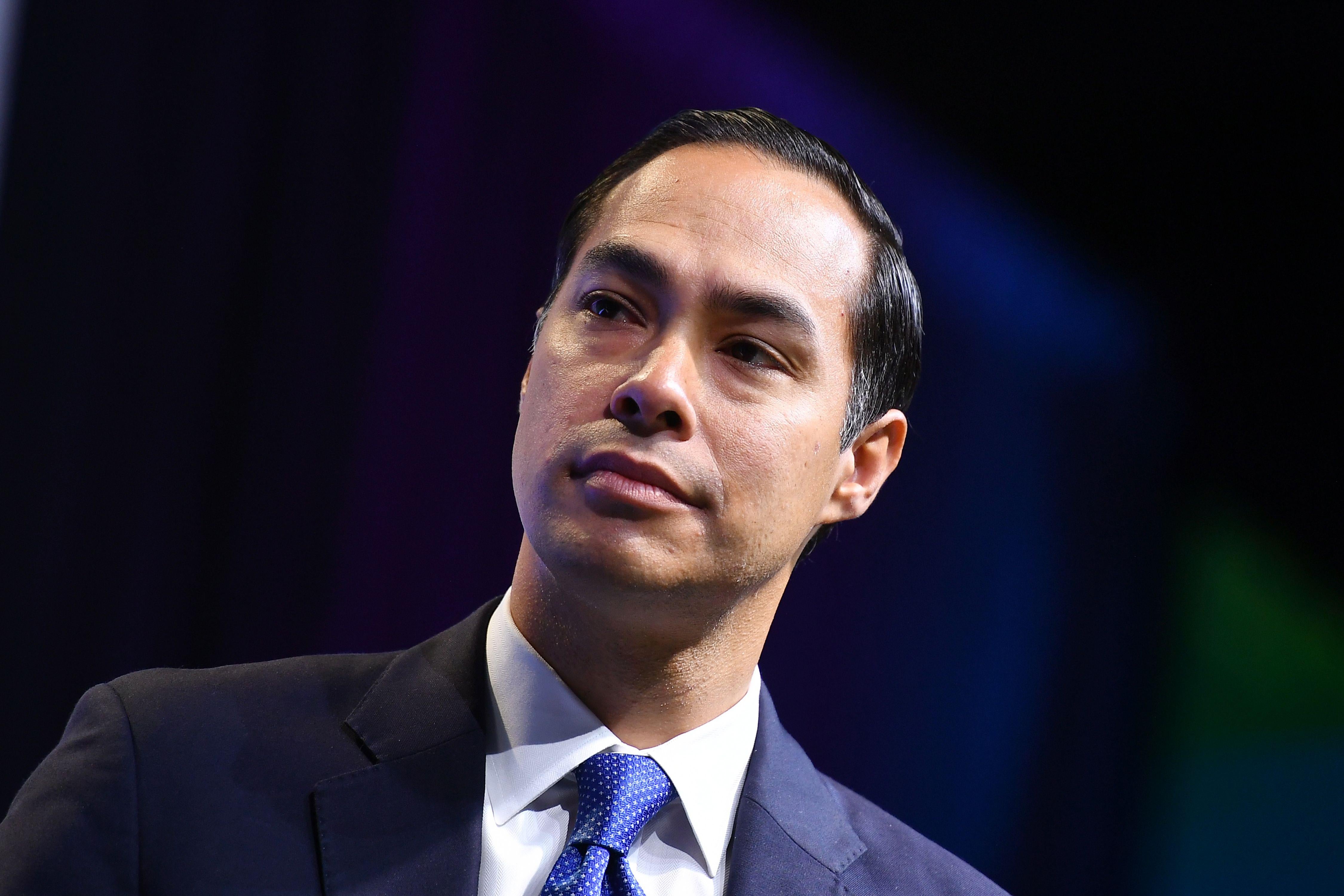 Julián Castro looks thoughtfully off to the right. He appears to be standing on a stage.