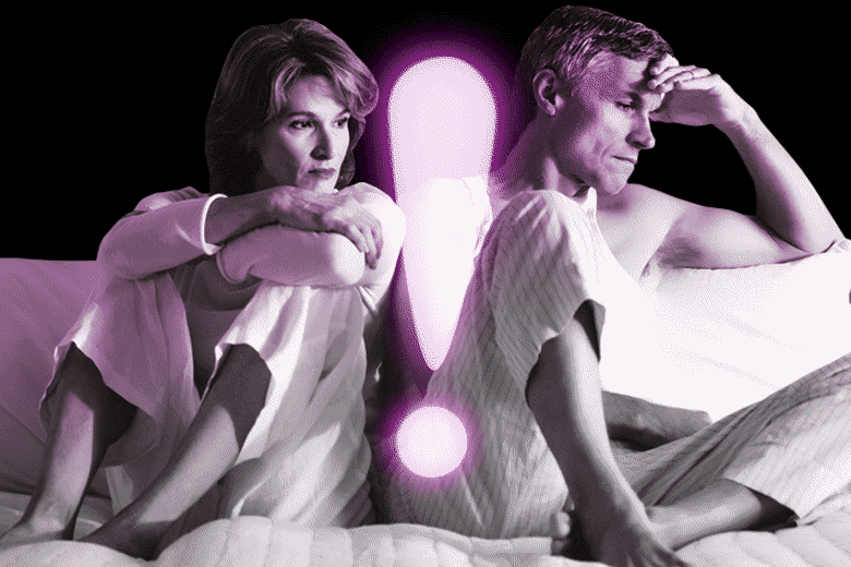 Woman and man sitting on bed looking pensive with a glowing exclamation point in between them.