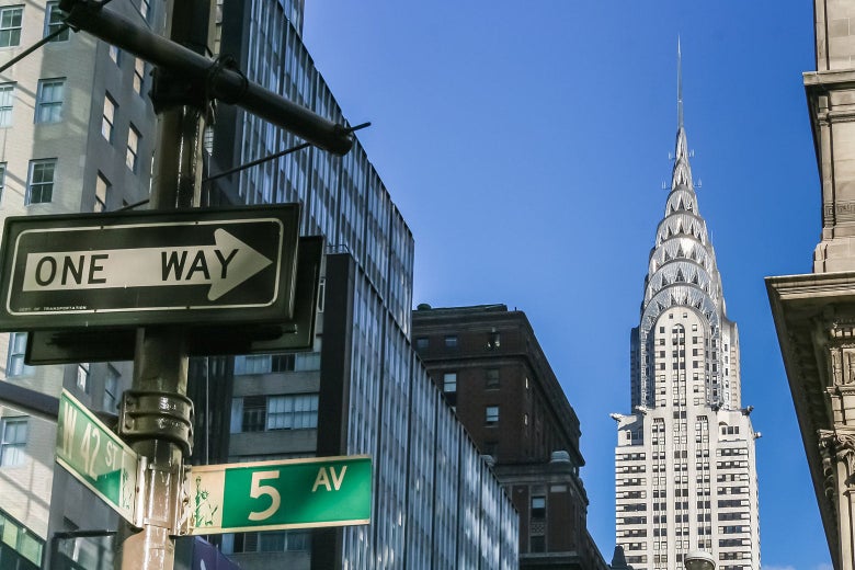 Low-angle shot of a New York City street sign and the Chrysler Building