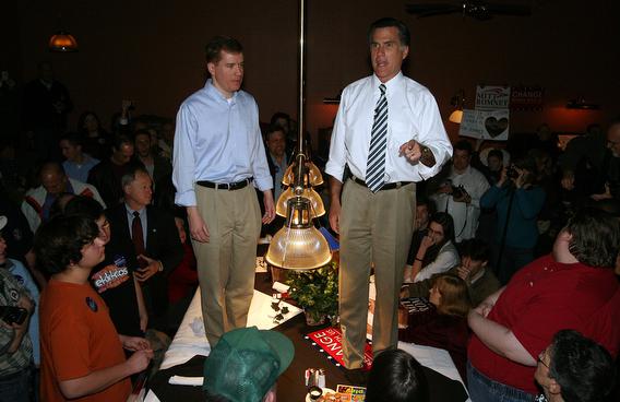 Standing on a pool table along side of Mo. Gov. Matt Blunt, republican presidential hopeful Mitt Romney (R) addresses supporters during a campaign stop at a Dave and Buster's Restaurant in Maryland Heights,