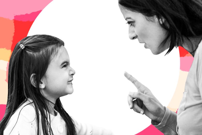 A mom scolds a grinning child.