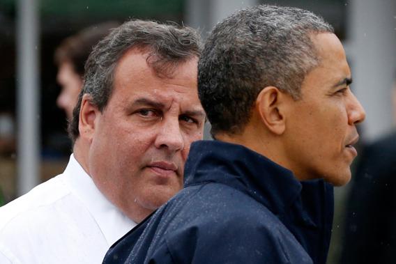 U.S. President Barack Obama and New Jersey Governor Chris Christie look out onto a beach near the boardwalk at Point Pleasant in New Jersey, May 28, 2013.