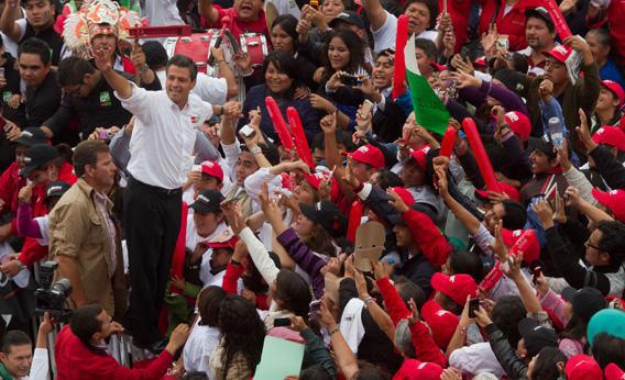The presidential candidate for Mexico's Institutional Revolutionary Party (PRI), Enrique Peña Nieto, waves at supporters during an electoral rally in Toluca, Mexico State, on June 27, 2012. 