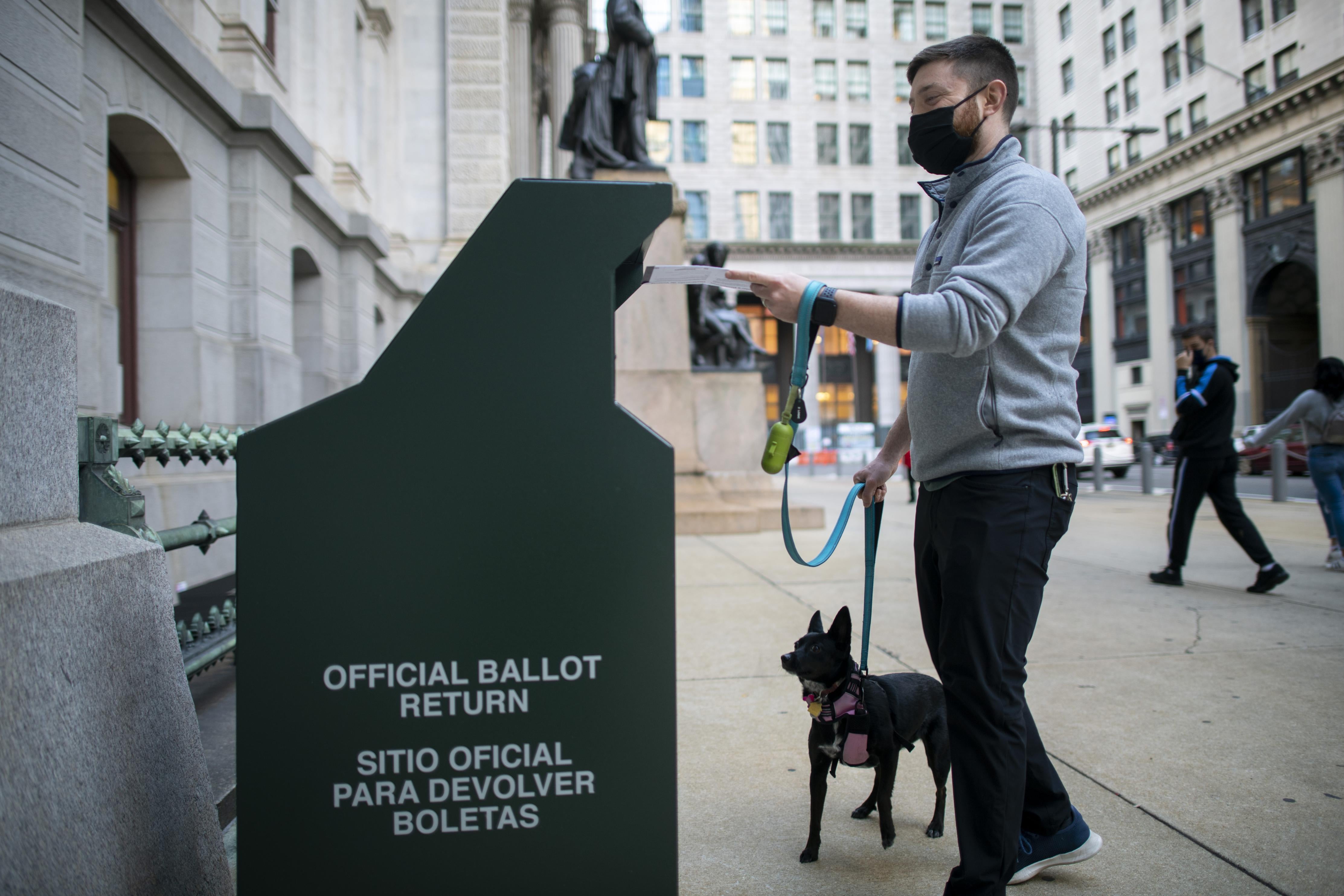 A voter casts his early voting ballot at drop box outside of City Hall on October 17, 2020 in Philadelphia, Pennsylvania.  With the election only a little more than two weeks away, a new form of in-person early voting by using mail ballots, has enabled millions of voters to already cast their ballots.  President Donald Trump won the battleground state of Pennsylvania by only 44,000 votes in 2016, the first Republican to do so since President George Bush in 1988.  (Photo by Mark Makela/Getty Images)