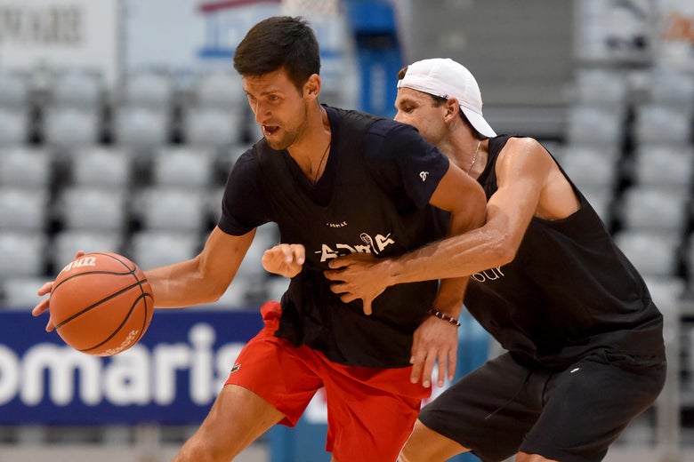 Dimitrov guards Djokovic, who is dribbling the basketball