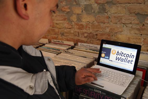 The proprietor of a shop selling vinyl records and that accepts Bitcoins for payment brings up, at the request of the photographer, the Bitcoins website on the proprietor's computer on April 11, 2013 in Berlin, Germany. 