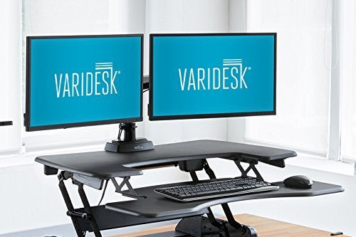 Two screens on an adjustable standing desk.