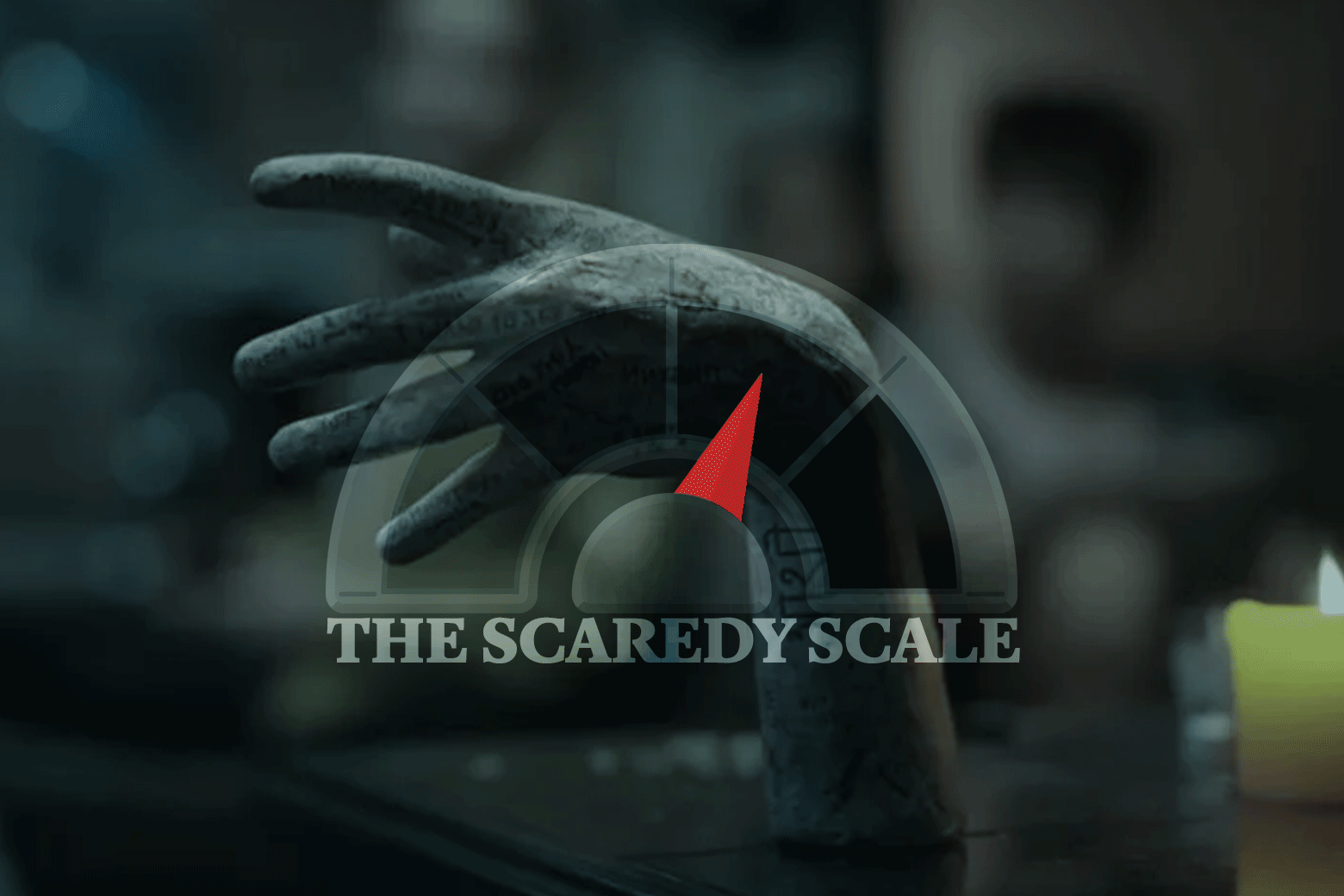 The Scaredy Scale needle is seen against a creepy stone statue hand as featured in the movie. 