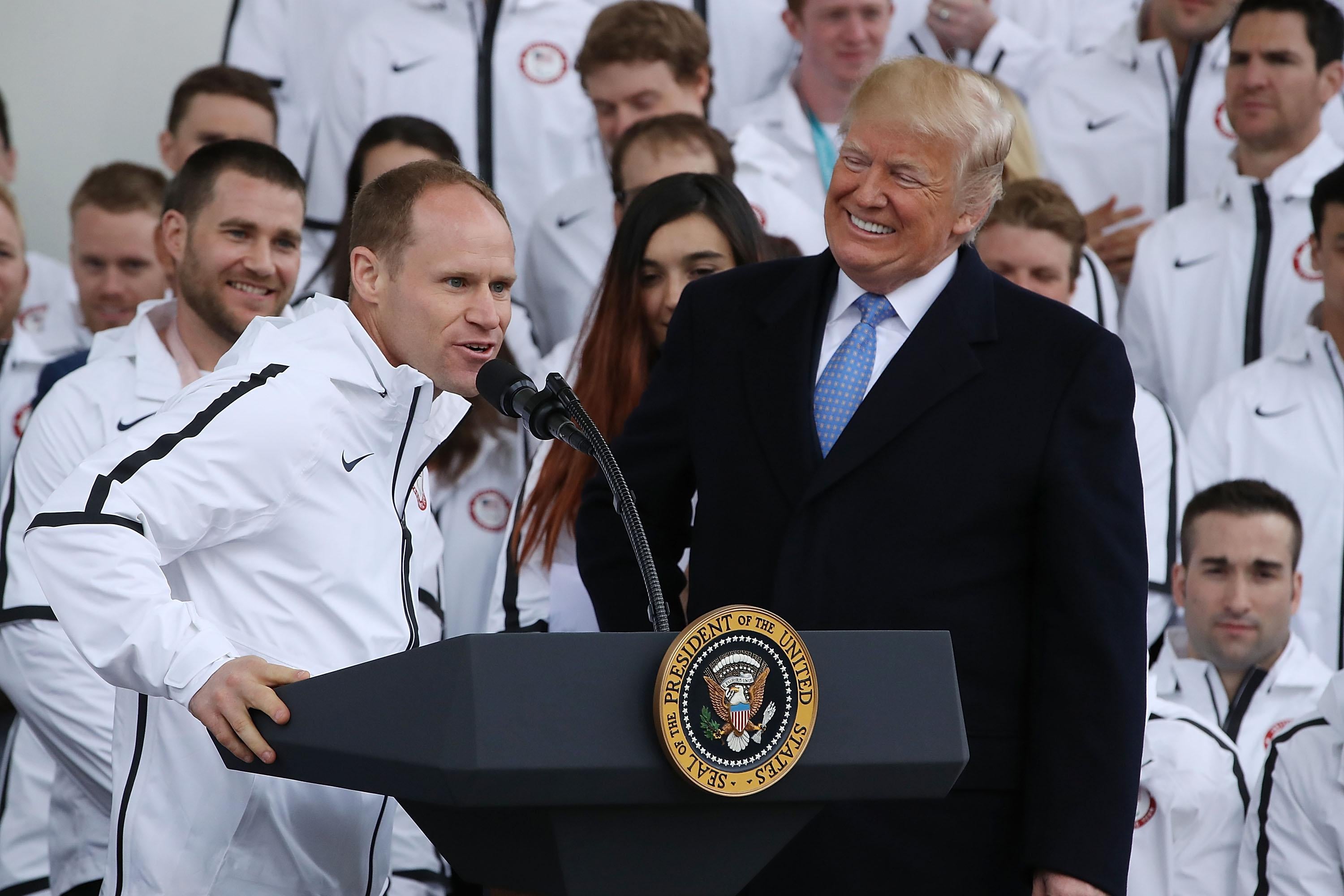 Paralympic medalist skiier Dan Cnossen speaks as President Donald Trump looks on during a celebration of the USA 2018 Winter Olympic and Paralympic Teams on the North Portico of the White House on April 27, 2018 in Washington, D.C. 