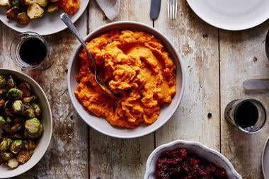 Mashed sweet potatoes in a bowl on a table.