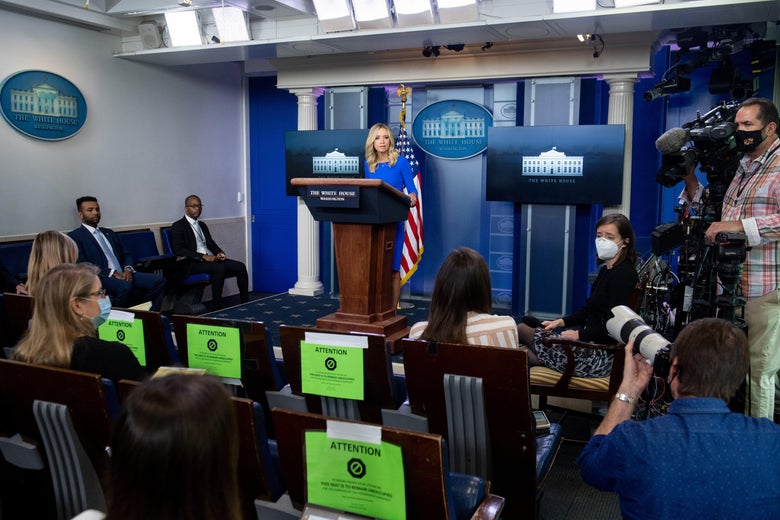 Kayleigh McEnany stands at a podium, holding a press briefing in the Brady Press Briefing Room of the White House.