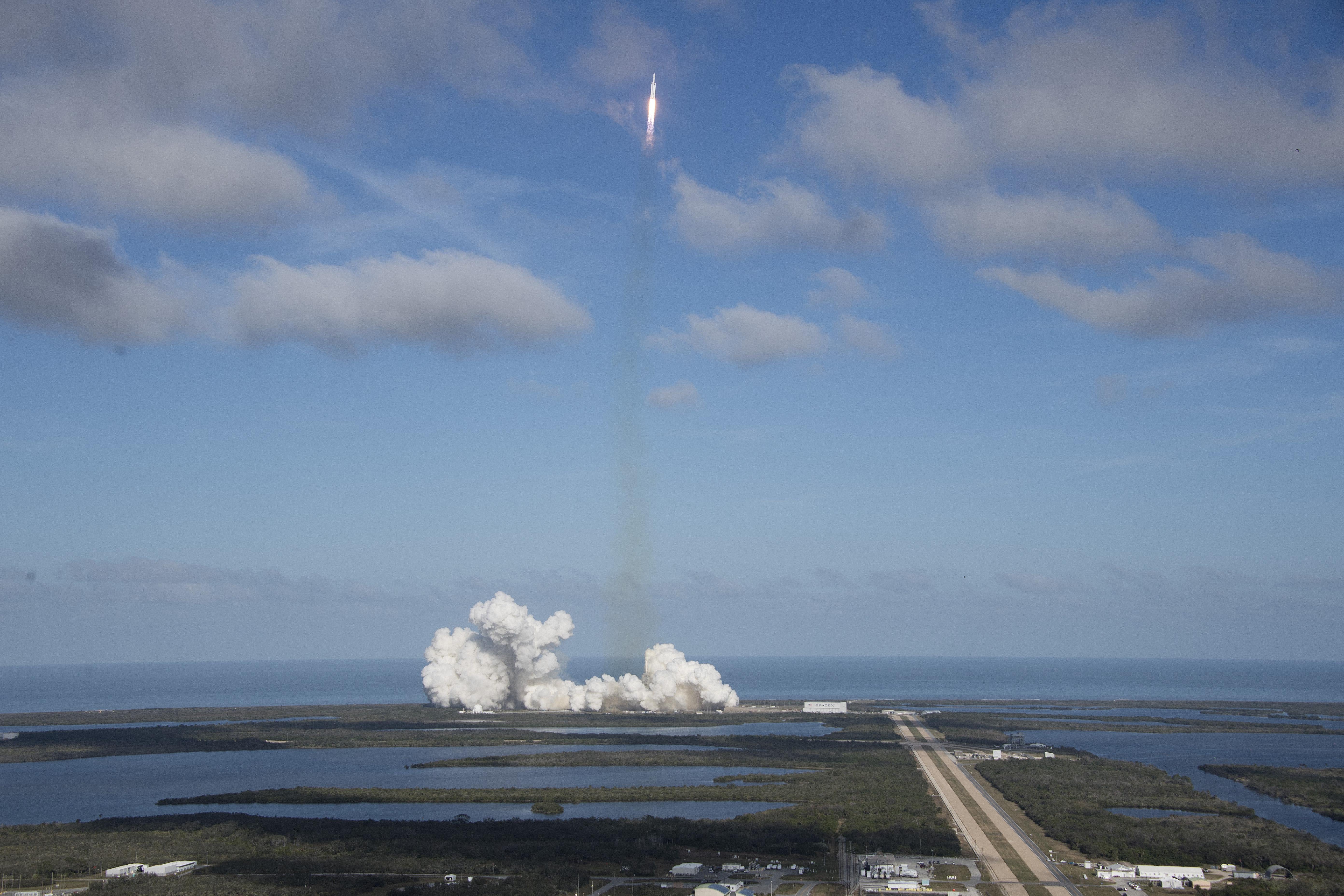 The SpaceX Falcon Heavy launches from Pad 39A at the Kennedy Space Center in Florida, on February 6, 2018, on its demonstration mission.
The world's most powerful rocket, SpaceX's Falcon Heavy, blasted off Tuesday on its highly anticipated maiden test flight, carrying CEO Elon Musk's cherry red Tesla roadster to an orbit near Mars. Screams and cheers erupted at Cape Canaveral, Florida as the massive rocket fired its 27 engines and rumbled into the blue sky over the same NASA launchpad that served as a base for the US missions to Moon four decades ago.
 / AFP PHOTO / JIM WATSON        (Photo credit should read JIM WATSON/AFP/Getty Images)