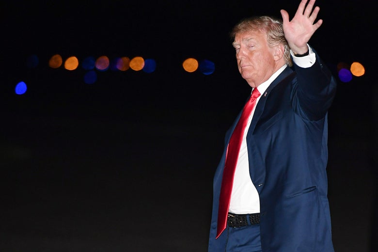 President Donald Trump waves upon arrival at Morristown Municipal Airport in Morristown, New Jersey, on August 4, 2018. 