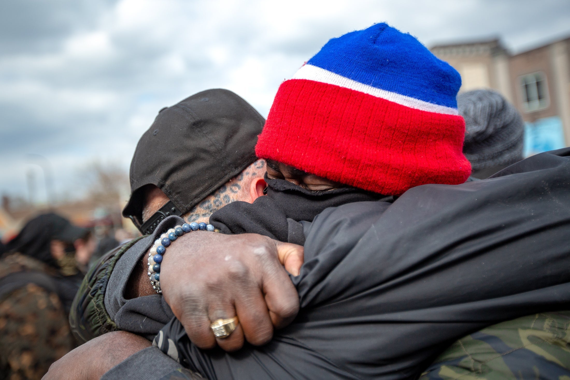 Two men hug in George Floyd Square.