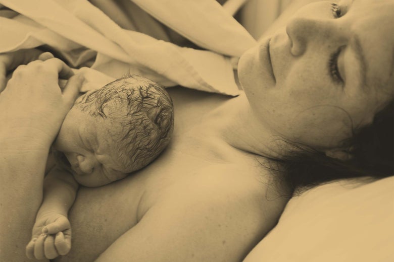 A newborn lies on its mother's chest.