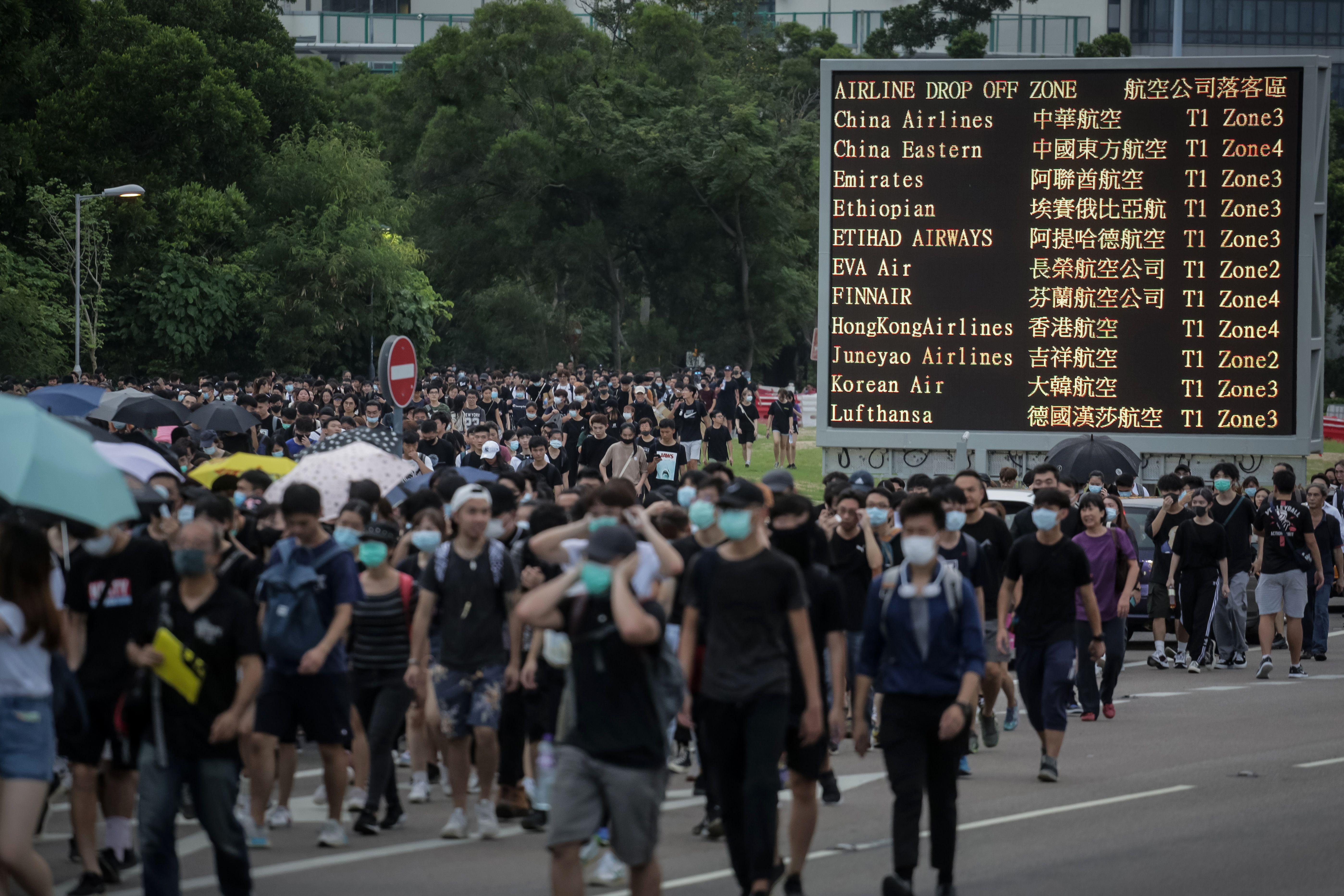 Protesters walk on a highway near Hong Kong's international airport.  