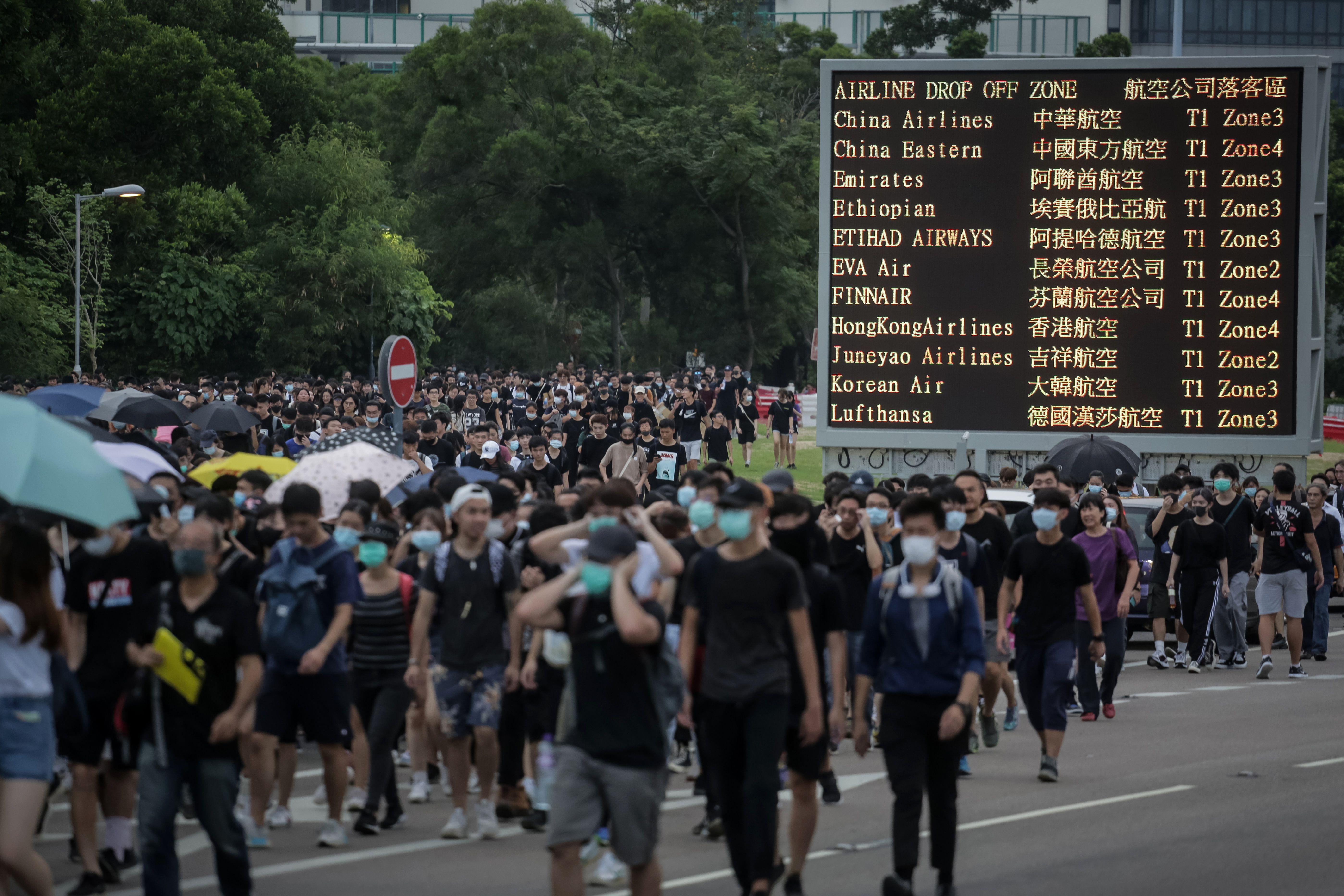 Protesters walk on a highway near Hong Kong's international airport.