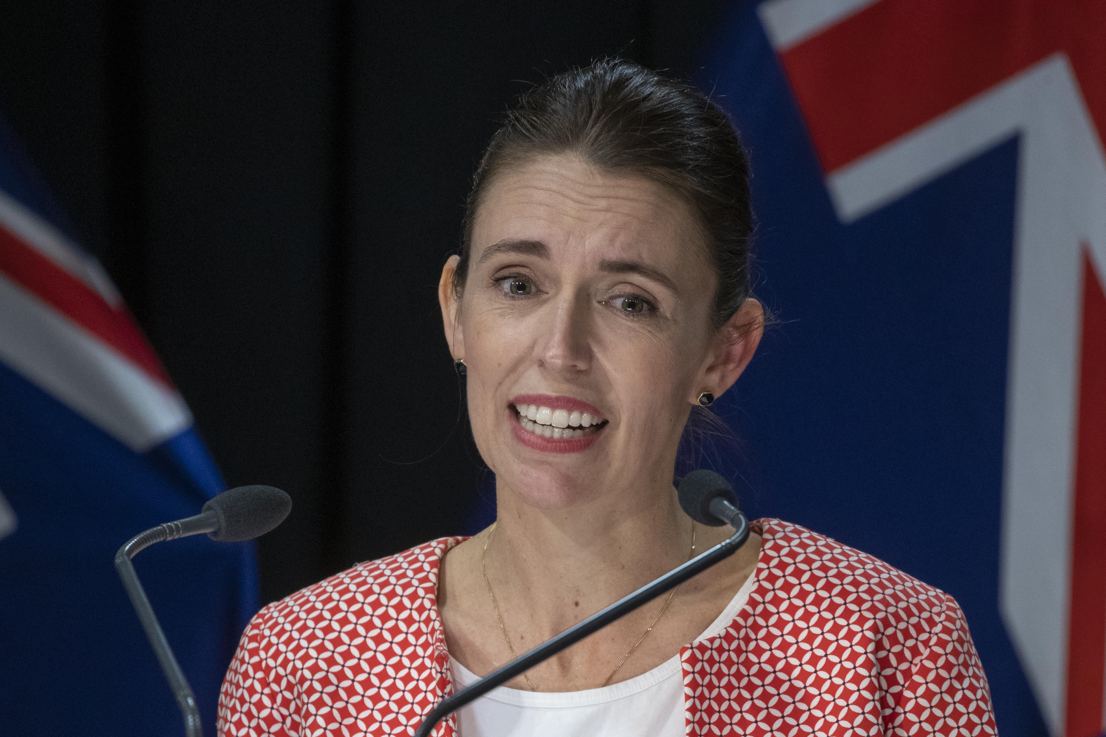 Ardern speaking at a mic
