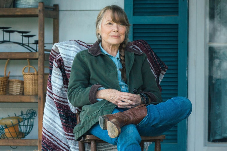 Sissy Spacek as Jewel, sitting on a porch and smiling.