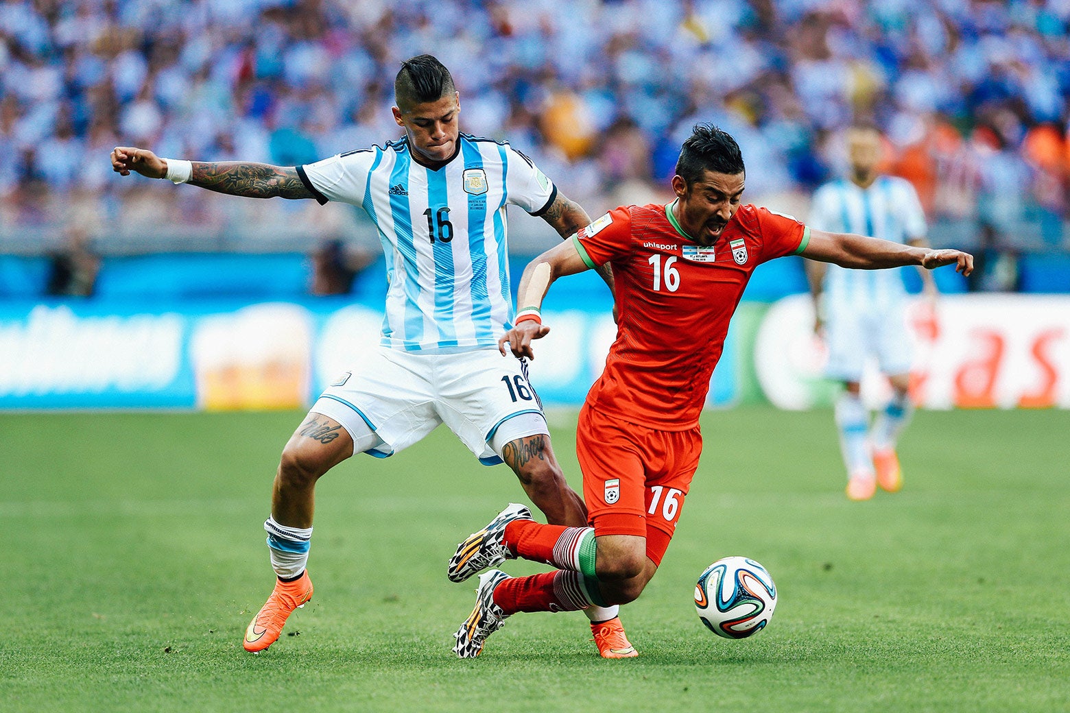 Marcos Rojo’s "pride" and "glory" tattoos are seen on his thighs as he challenges another player for the ball.