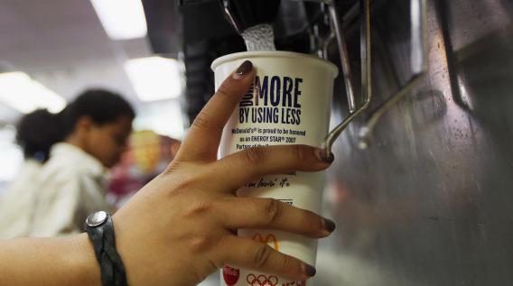 A customer fills a 21 ounce cup with soda at a 'McDonalds'.