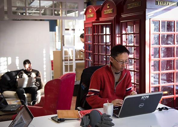 Employees of start-up companies work at their designated spaces at the offices of 1776 business incubator in Washington DC, February 11, 2014.
