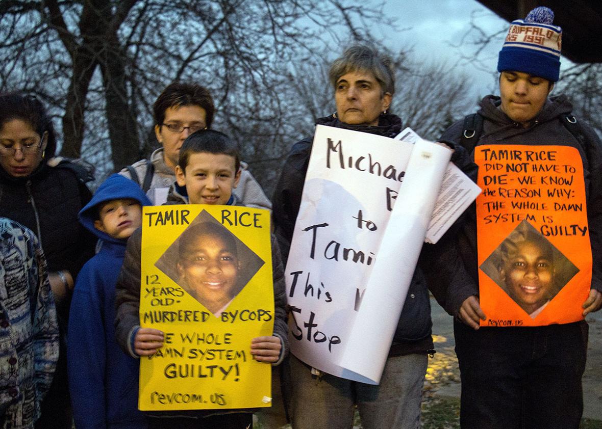 People display signs at Cudell Commons Park in Cleveland, on Nov. 24, 2014, during a rally for Tamir Rice.