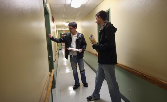 Democratic party volunteers Chris Lettero, left, and Matt Lattanzi knock on apartment doors while canvasing for votes Sunday in Youngstown, Ohio.