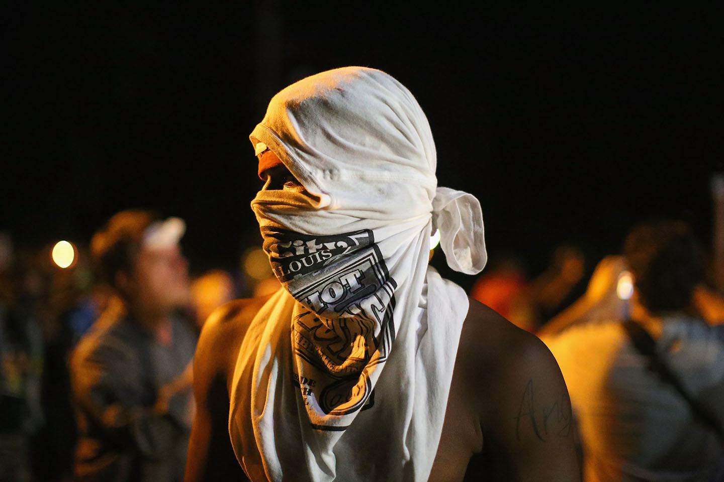 Demonstrators protest the shooting death of teenager Michael Brown on August 13, 2014 in Ferguson, Missouri. 