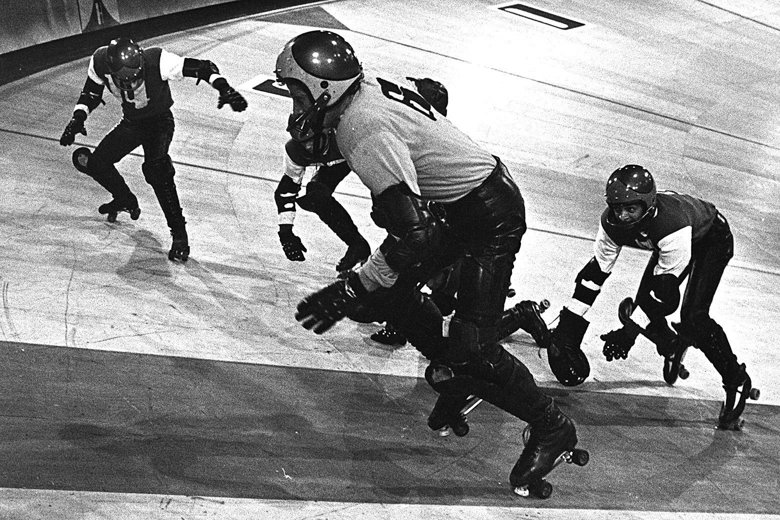 Men chase each other in roller skates.