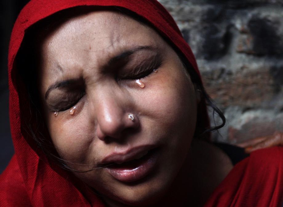 A Pakistani Christian woman weeps after visiting her home, which was damaged by an angry Muslim mob in Lahore, Pakistan, on March 10, 2013. Hundreds of Christians clashed with police in eastern and southern Pakistan on Sunday, a day after a Muslim mob burned dozens of homes owned by members of the minority religious group in retaliation for alleged insults against Islamic Prophet Muhammad.