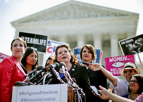 Lori Windham, senior counsel for the Becket Fund for Religious Liberty, addresses the media in front of the Supreme Court after the decision in Burwell v. Hobby Lobby on June 30, 2014.