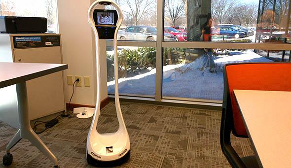 Teacher Thomas Fech, who teaches high school students remotely in a Columbus charter school, operates a telepresence robot.