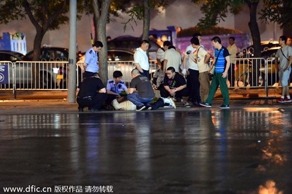 Police officers catch a foreign drug dealer in a campaign in Sanlitun, a popular Beijing bar area, on May 24