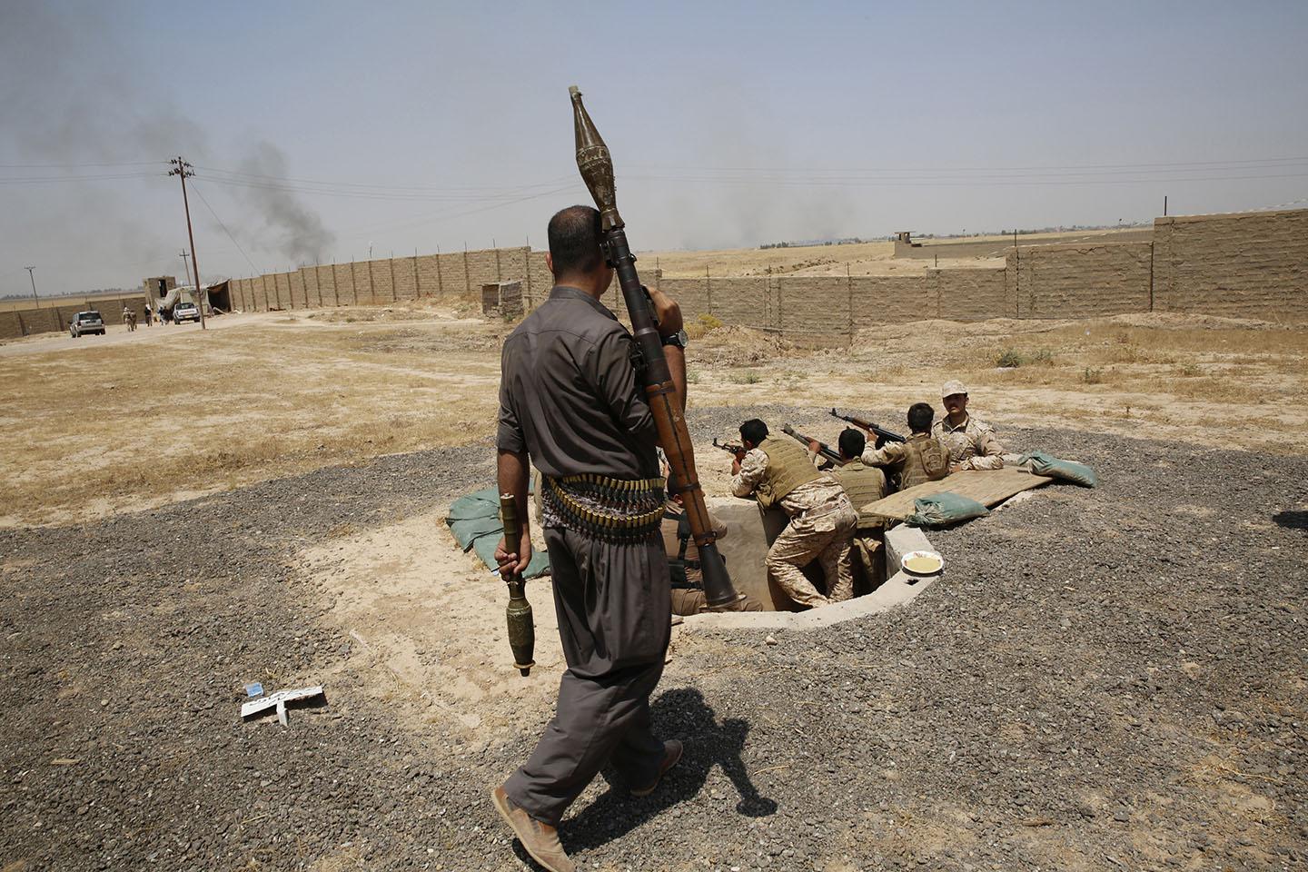Members of Kurdish security during clashes with ISIS militants in the village of Basheer, south of the city of Kirkuk, June 29, 2014.