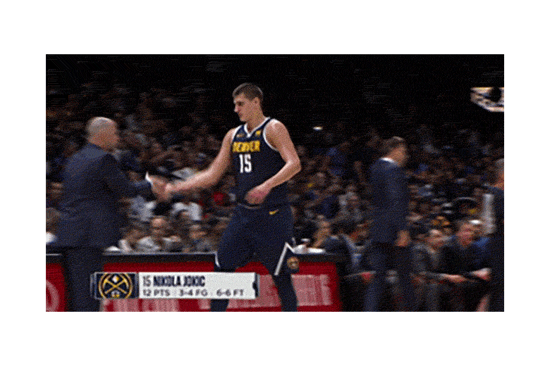 Jokic, in a navy jersey, walks with his teammates during a game.